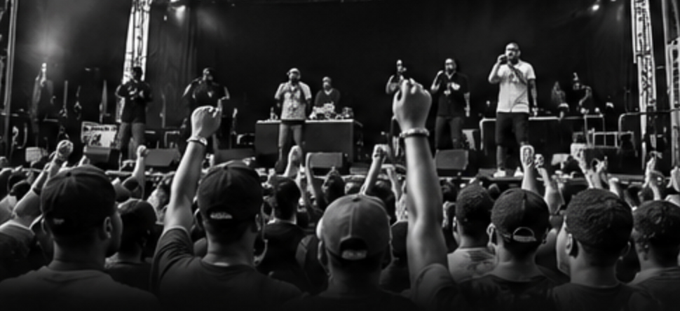 A crowd watching performers on an outdoor stage