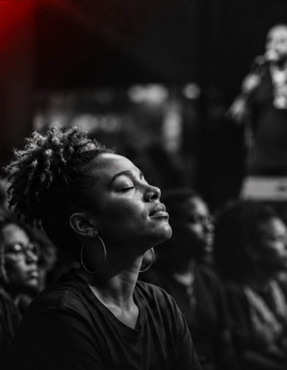 An audience member listening with her eyes closed during a performance